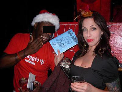 Undercover WitchesBrewPress agent on a mission to get club goers to pose with a Psycho Bunny comic. Photo by Michele Witchipoo, Dec. 2008 at LIT Lounge. 